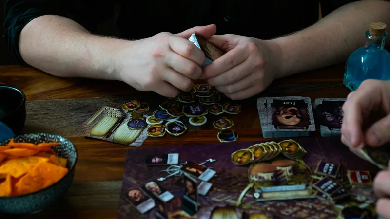 Collectible cards, dice, and tokens on a leather surface